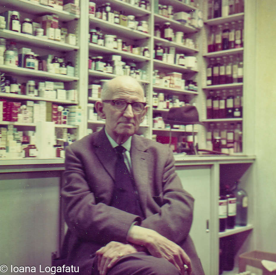 Elderly man sitting in a vintage pharmacy setting