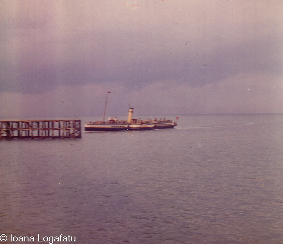 Boat cruising near the pier on a cloudy day