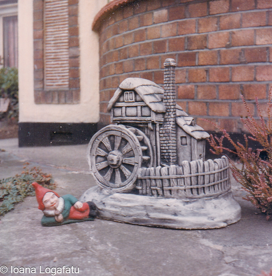 Decorative garden scene with gnome and watermill