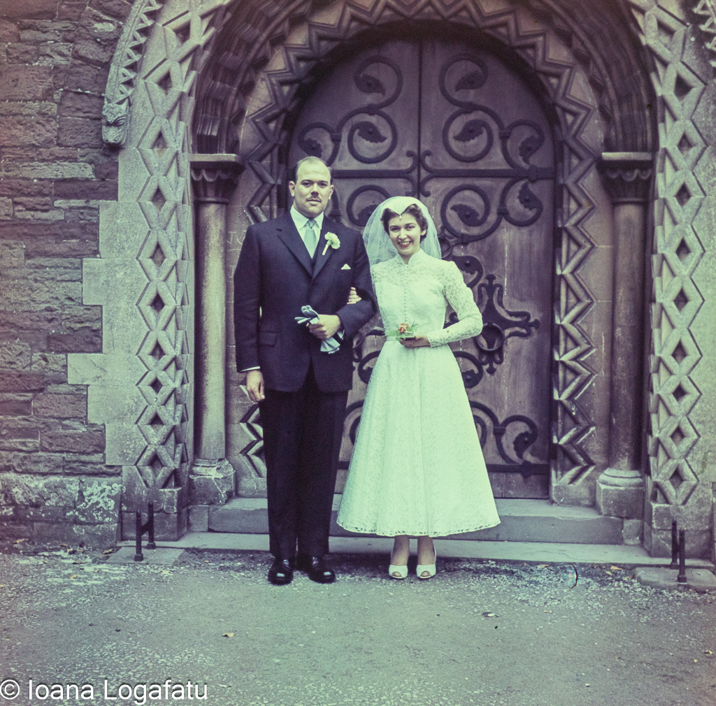 Couple standing in front of ornate church entrance