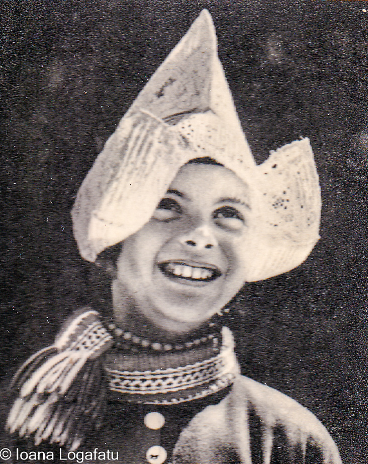 Child smiling with traditional hat and attire