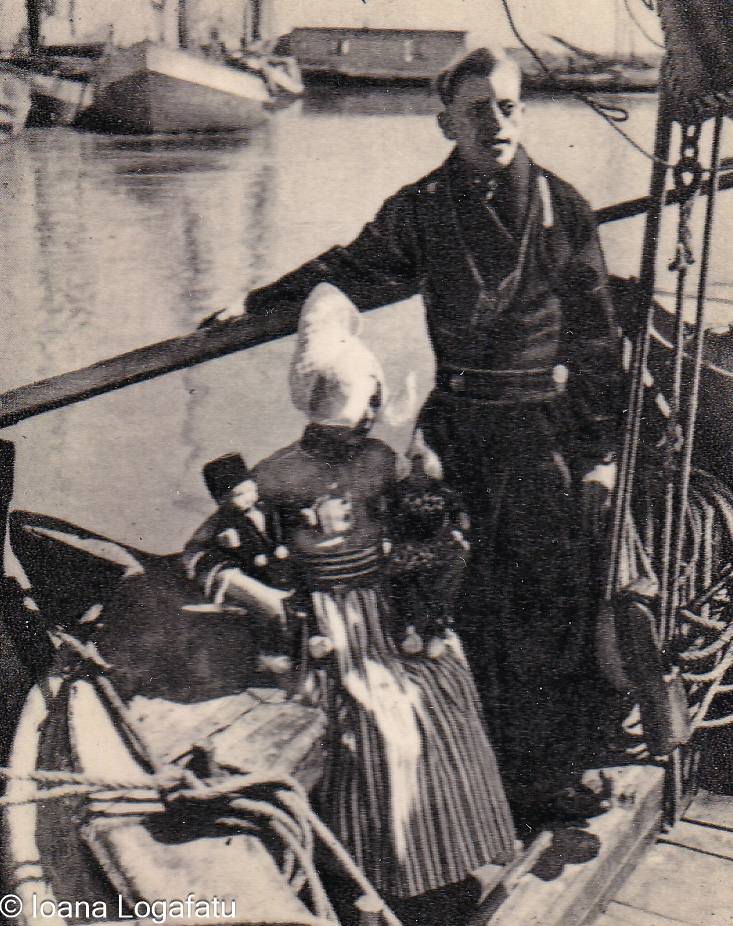 Fisherman with child at the waterfront in spring