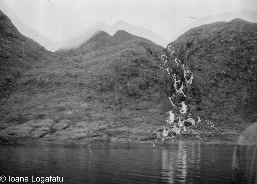 Serene mountain landscape with cascading waterfall