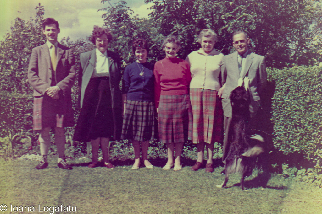 Family gathering in a garden with a dog
