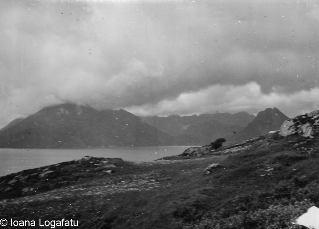 Coastal view with mountains and cloudy sky