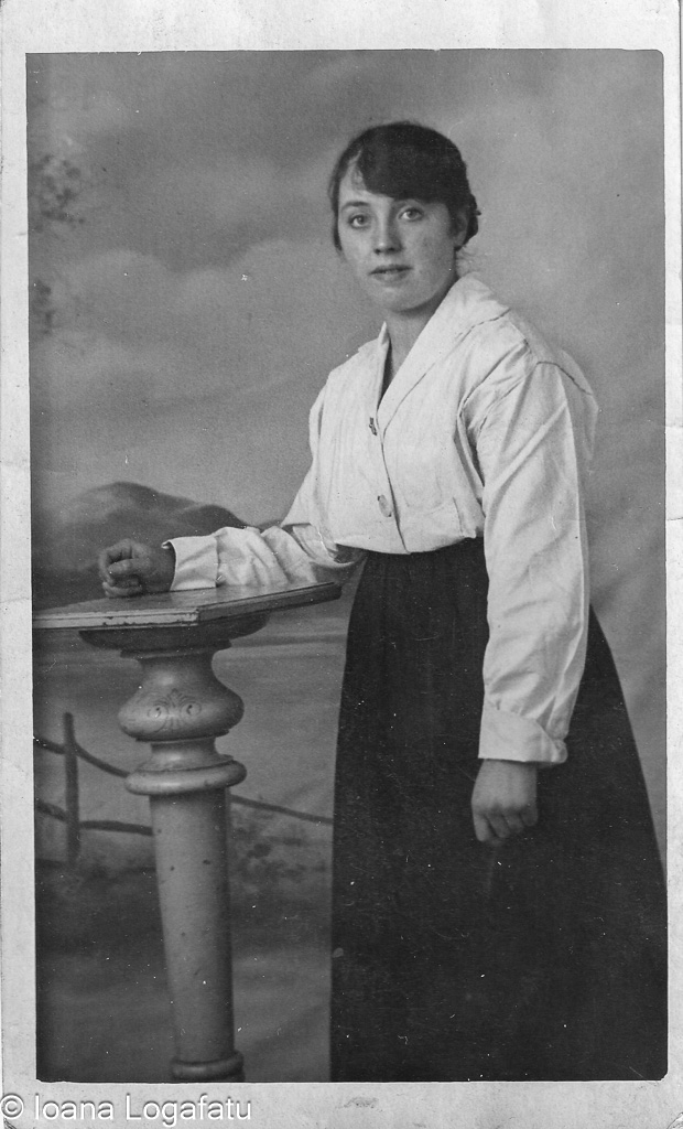 Young woman in vintage attire by a pillar