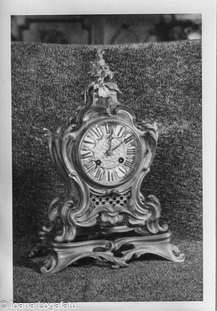 Intricate antique clock resting on plush fabric