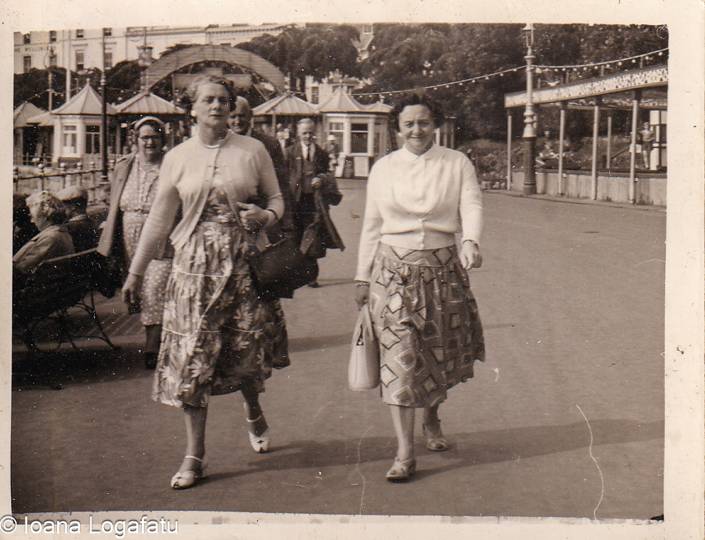 Women stroll on the sunny seaside