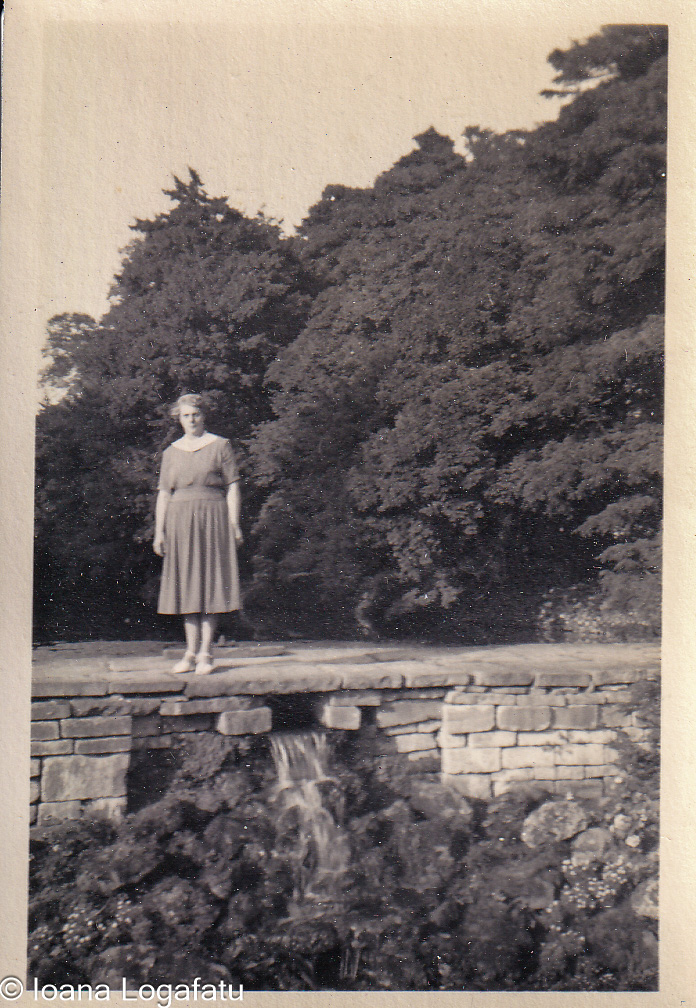 Woman standing gracefully by a serene waterfall