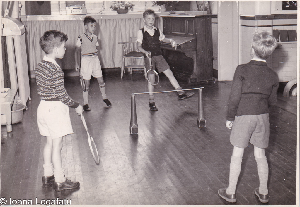 Boys play a friendly game in an old gym