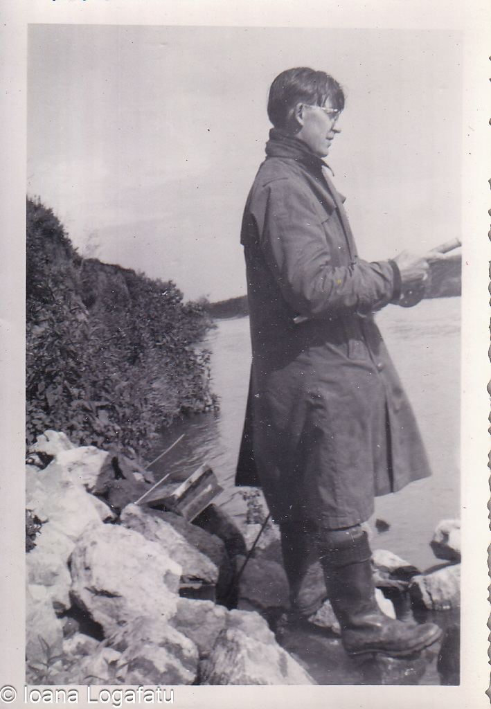 Reading quietly by the riverbank on a chilly day