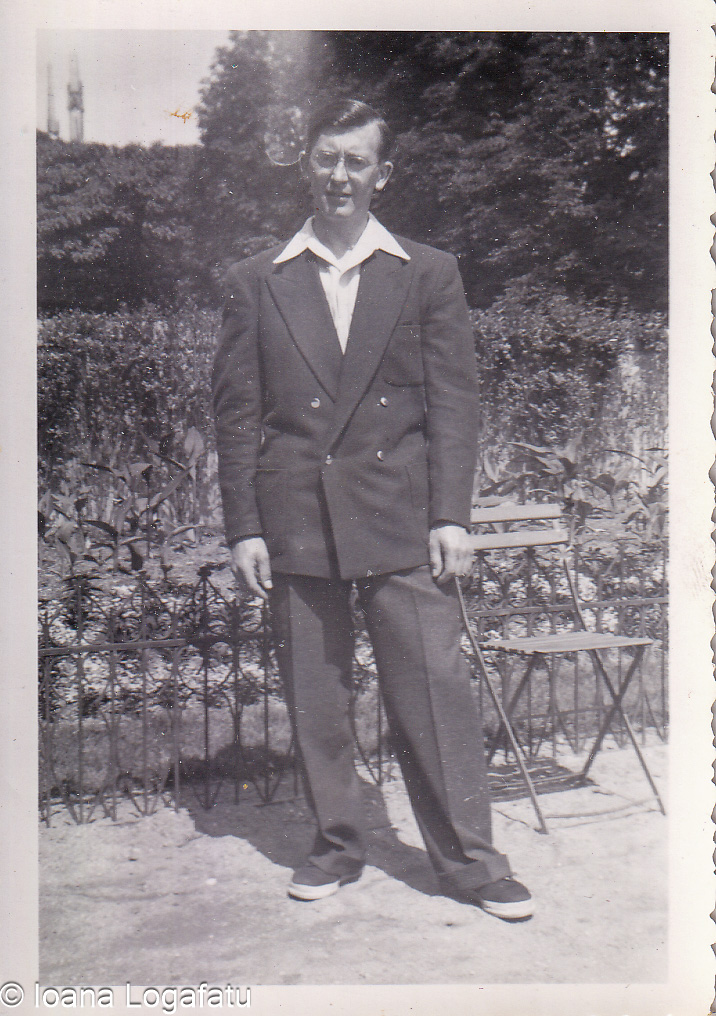Man in stylish outfit standing near garden chair