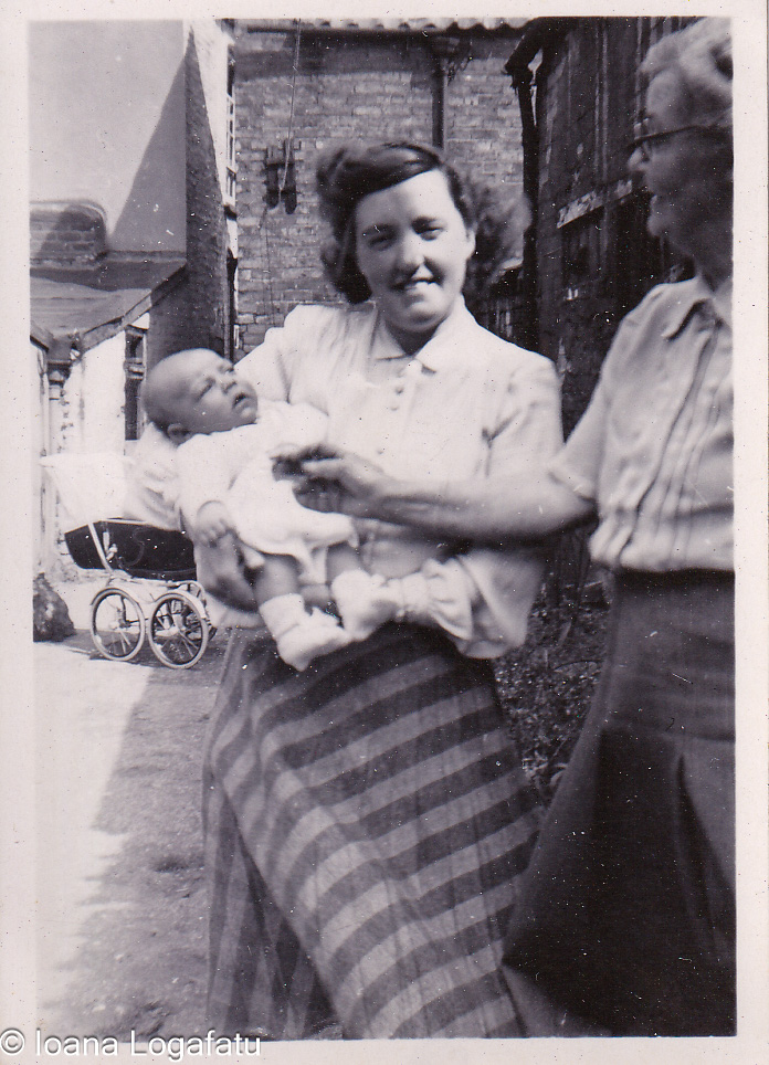 Holding a newborn on a sunny stroll through town