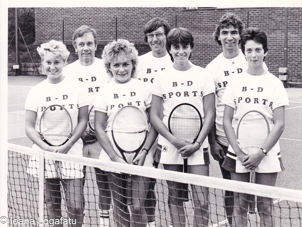 Tennis team posing with pride on the court