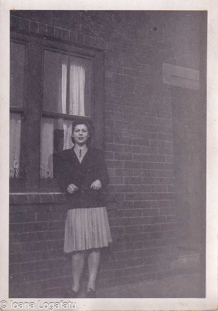 Vintage portrait of a woman by a brick wall