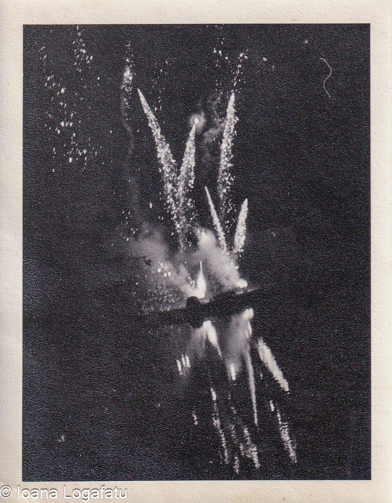 Fireworks light up the night sky over calm waters