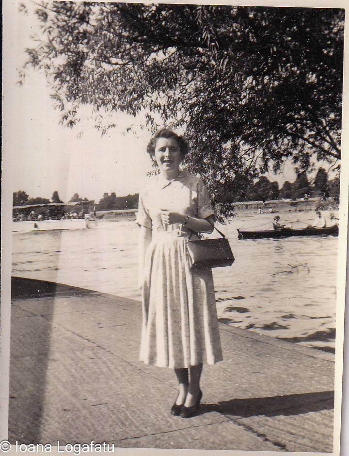 Woman by the water in a serene riverside setting