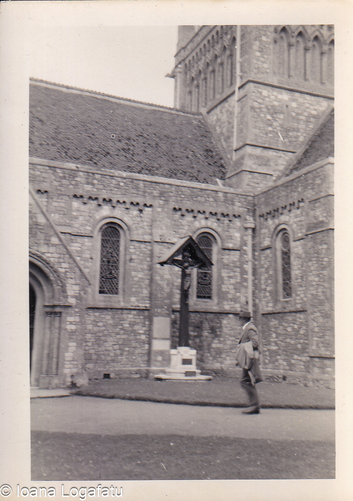 Walking past a historic church building in the sun