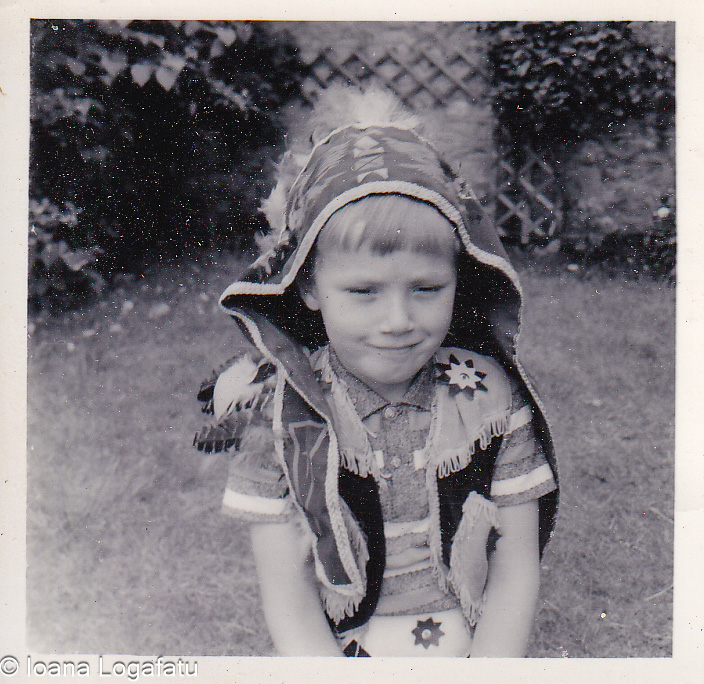 Young boy dressed in traditional attire outdoors