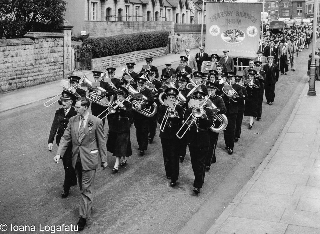 Marching band parades through city streets