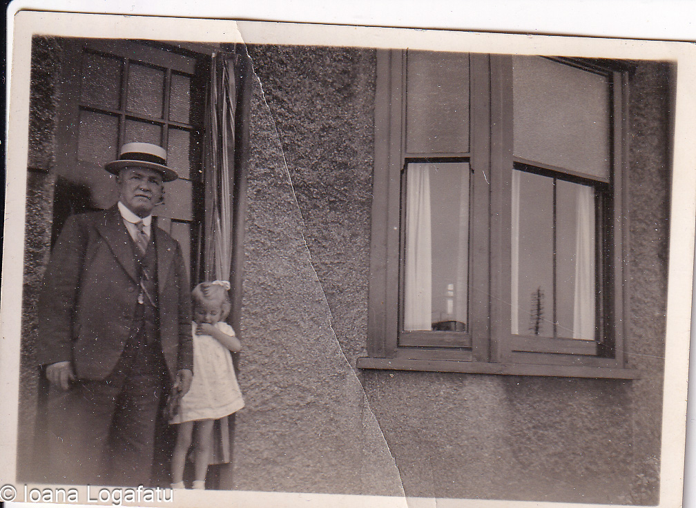 Elderly gentleman and child near a quaint building
