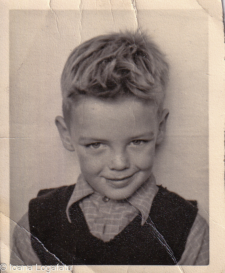 Smiling boy poses for vintage photo