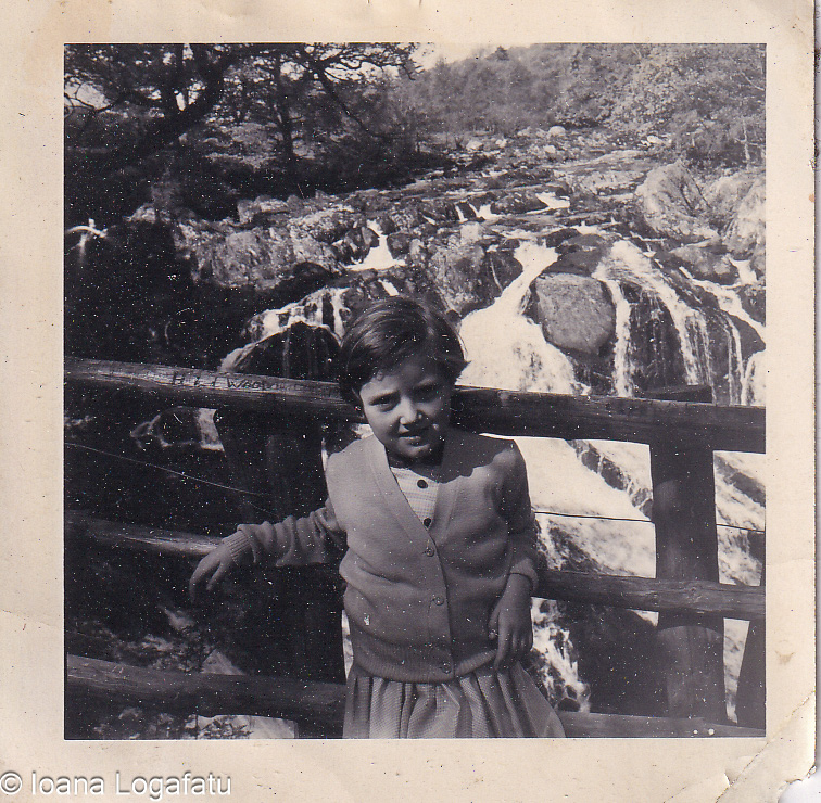 Girl admires nature at a waterfall