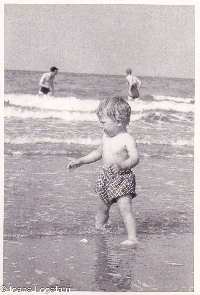 Child playing at a sunny beach shore