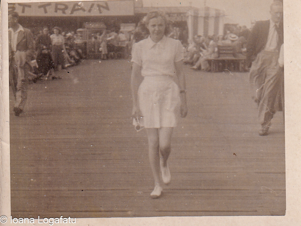 Woman walking confidently on a busy pier in summer
