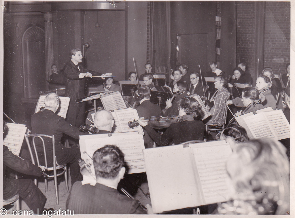 Orchestra plays under conductor's guidance