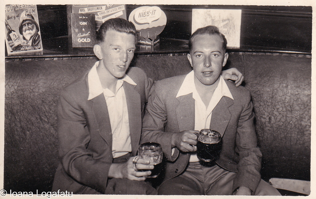 Two friends enjoying drinks in a cozy bar setting
