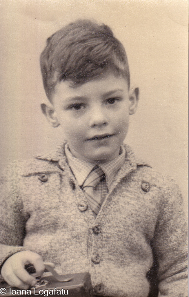 Young boy holding a toy camera, captured in time