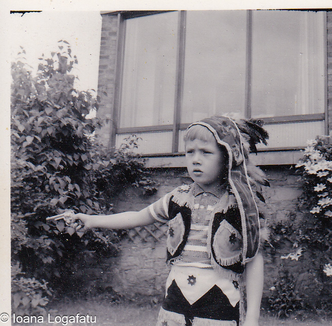 Young child in playful costume pointing outside