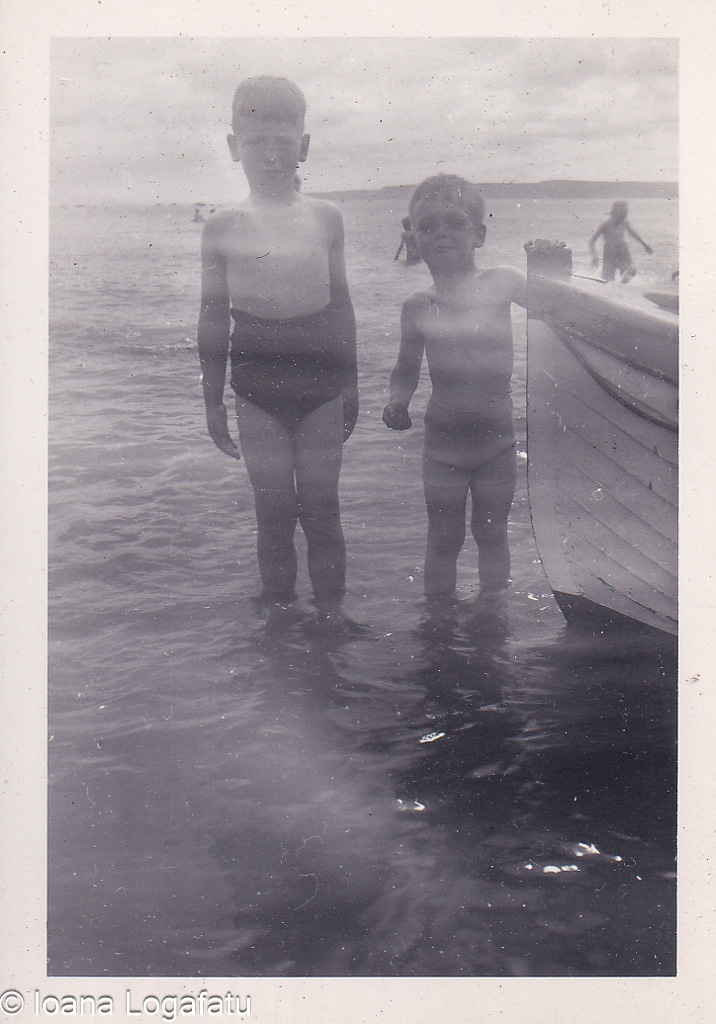 Two boys playing near the water on a summer day