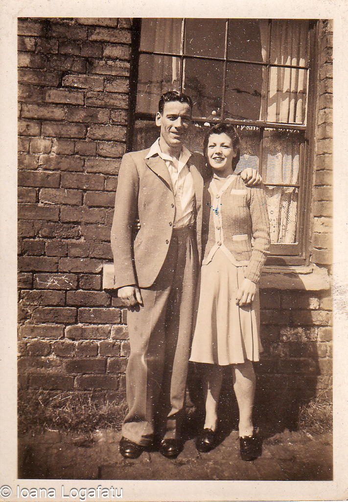 Couple enjoying a sunny day by the brick wall