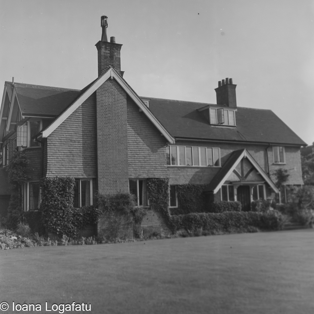 Historic manor house surrounded by lush greenery