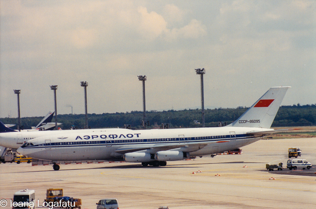 Historic Soviet-era aircraft at bustling airport