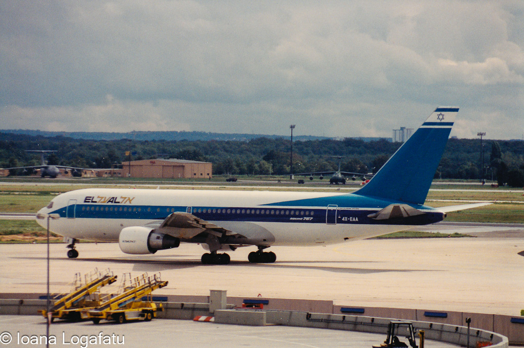 Airplane taxiing on a busy runway at an airport