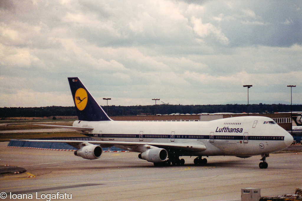 Jumbo jet at the airport, cloudy skies