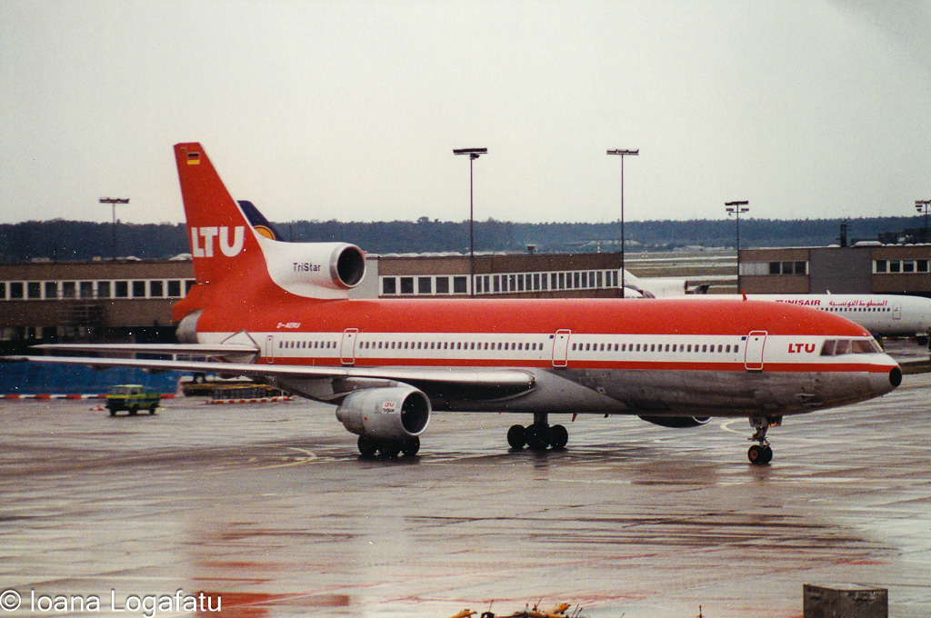 Red aircraft preparing for takeoff on a rainy day