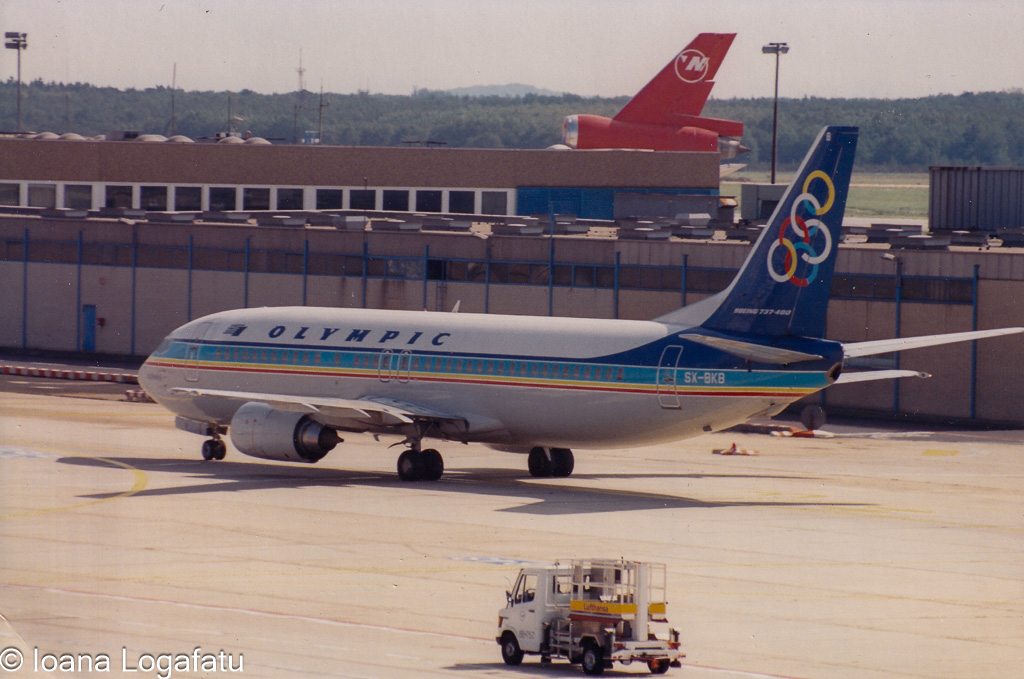Vintage aircraft taxiing at a lively airport