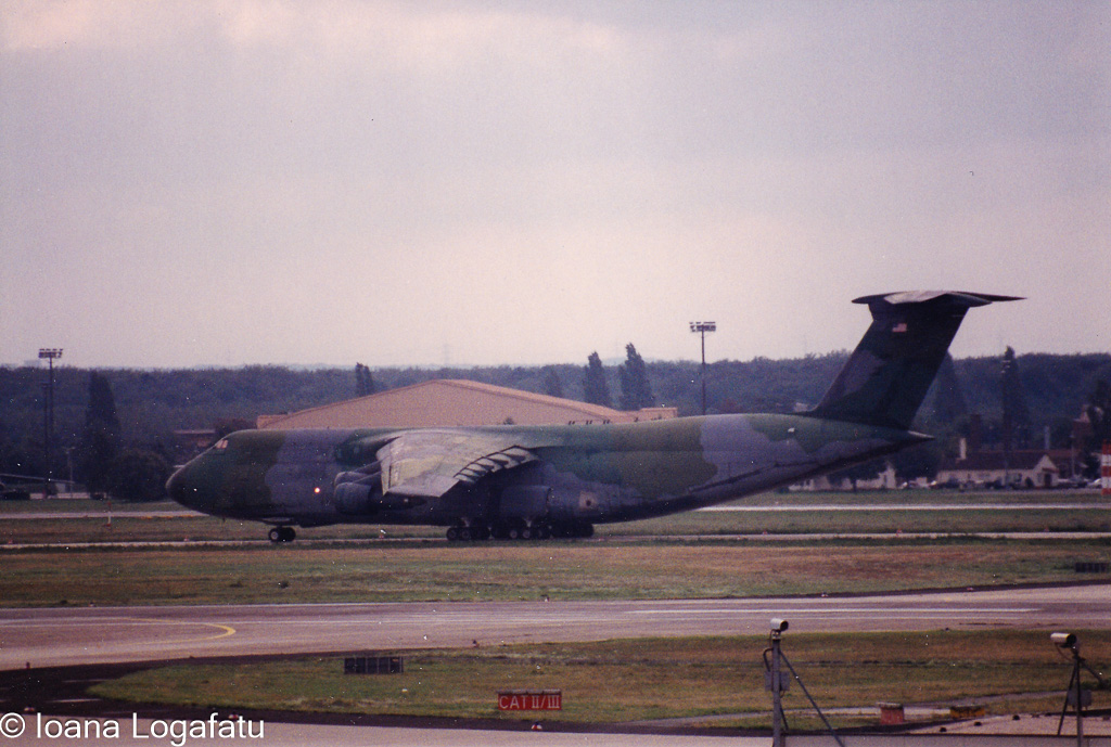 Large cargo aircraft landing at military airfield