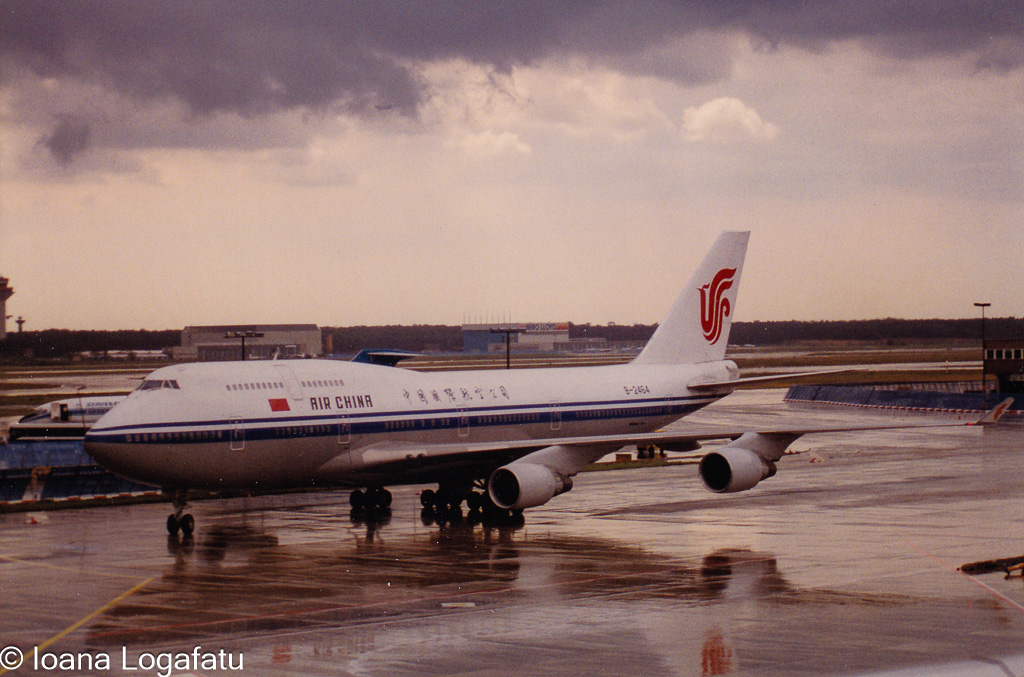 Airliner on tarmac under cloudy skies at dusk