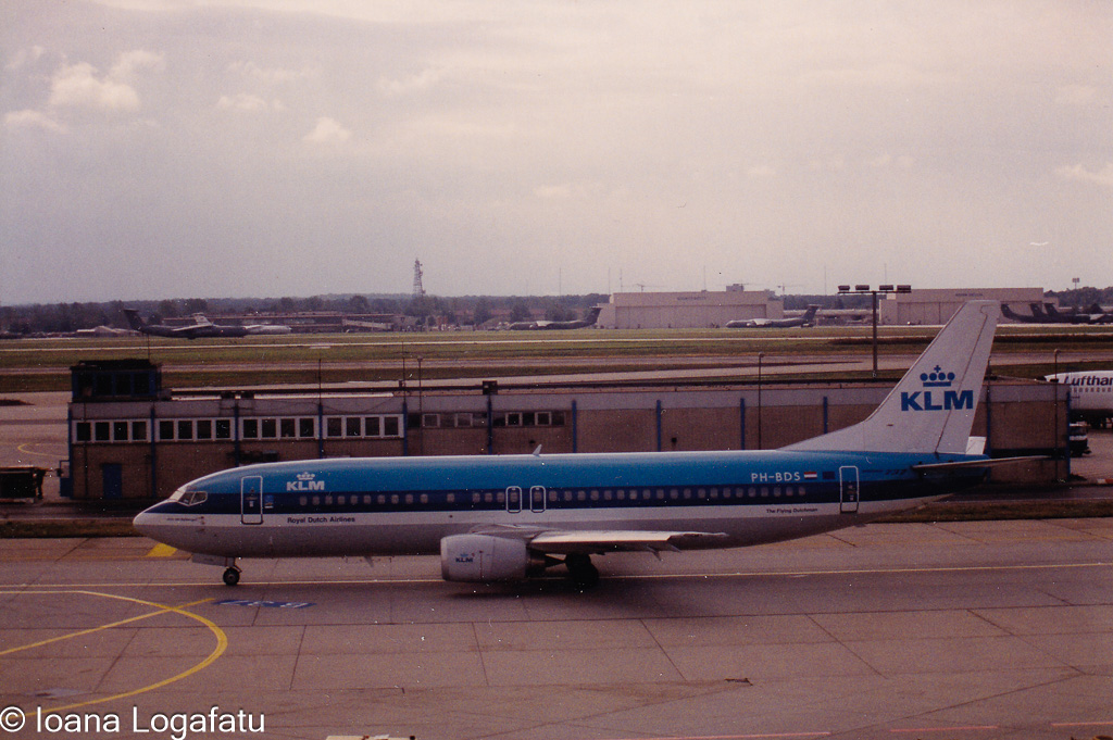 Old aircraft parked at the busy airport runway