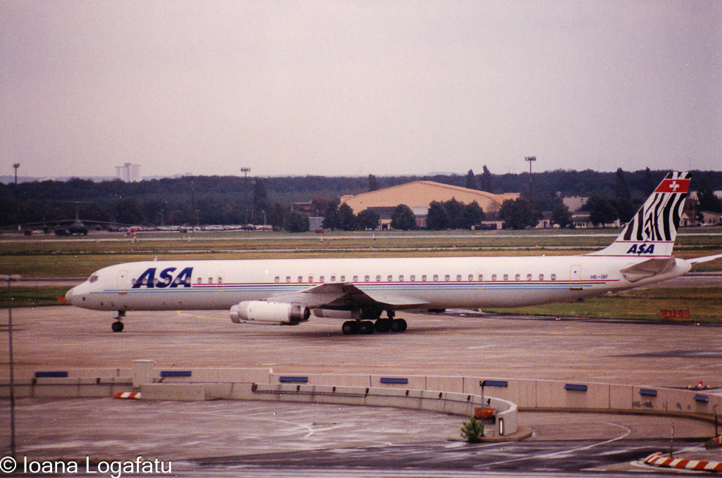 Airplane taxiing on runway near airport terminal