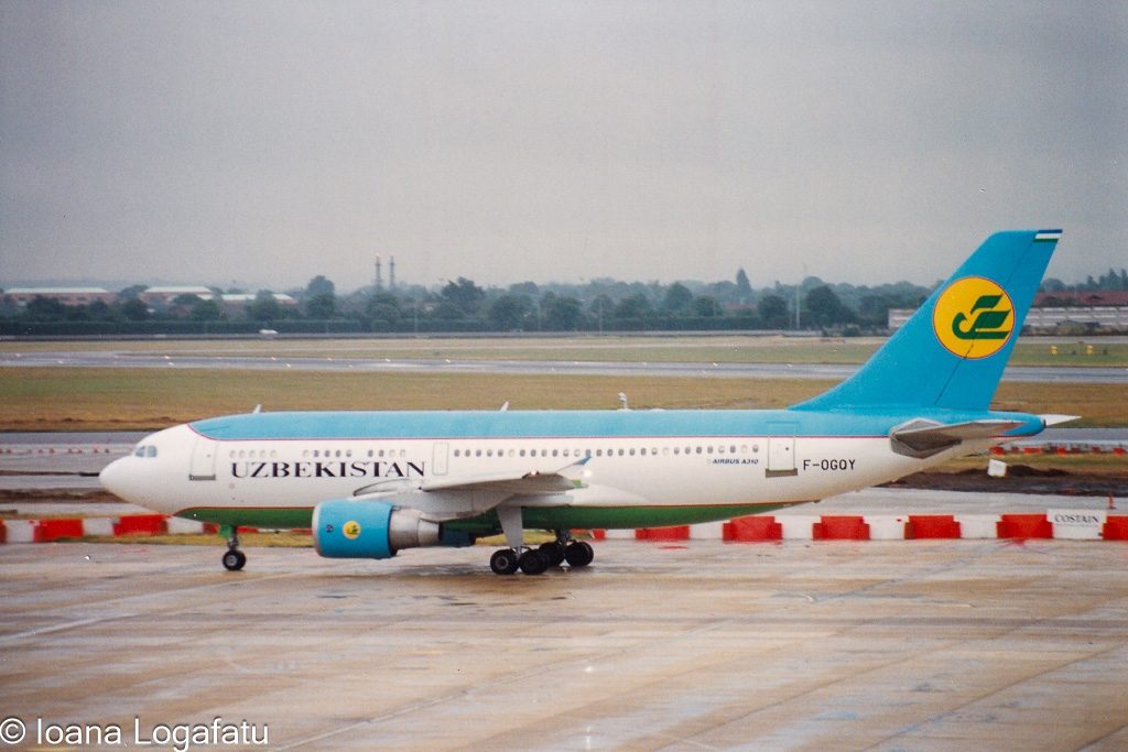 Uzbekistan Airways jet taxiing on a cloudy day