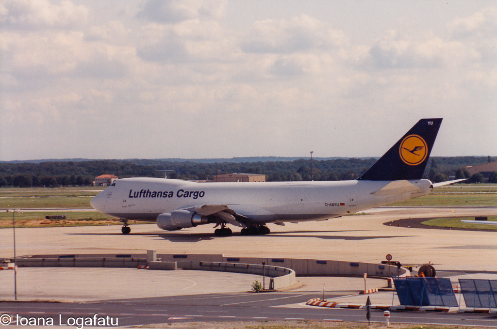 Cargo plane taxiing under a sunny sky