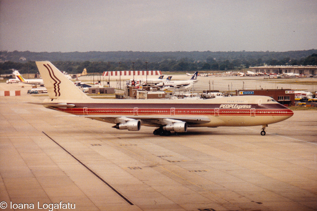 Vintage airplane taking off from a busy airport