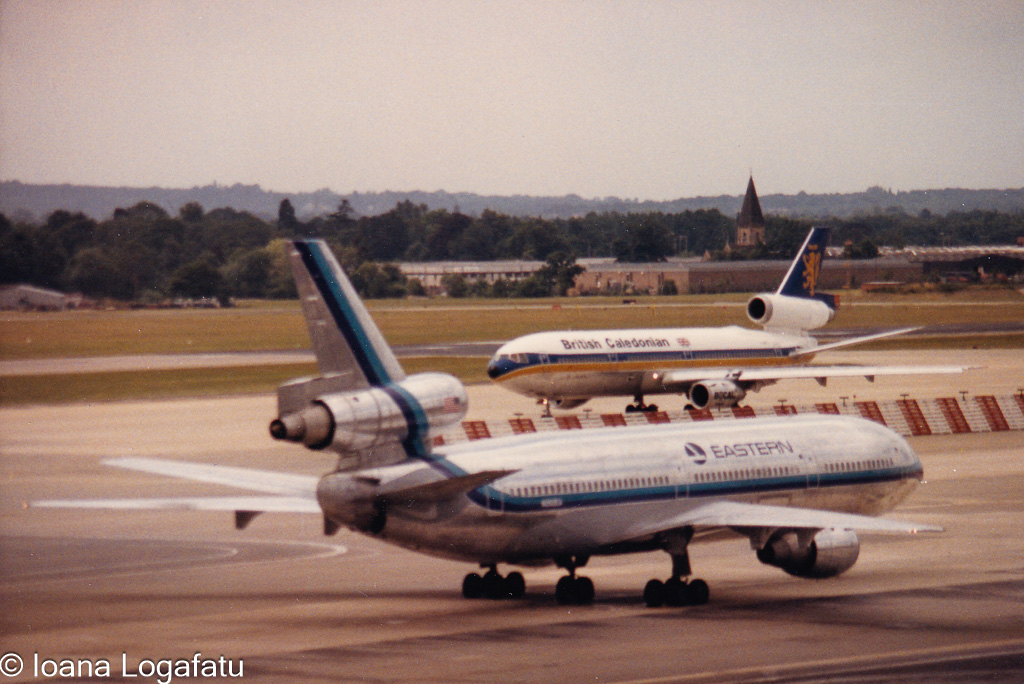Vintage aircrafts at a bustling airport in the 80s