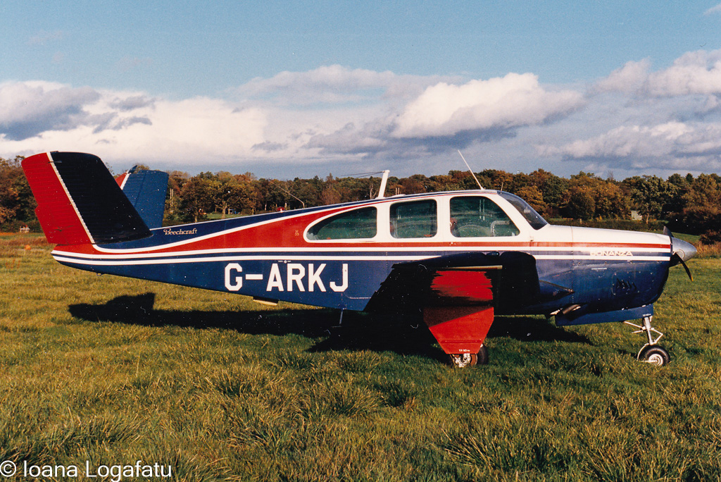 Vintage aircraft resting on lush green field